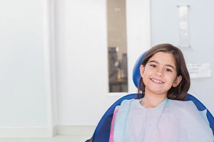Smiling girl in dental treatment chair