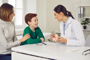 Mother and son talking to dentist