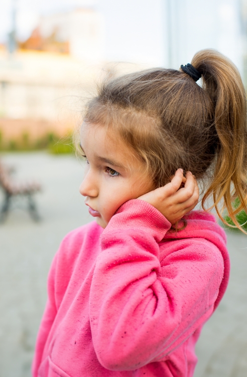 Girl holding her face in pain needing pediatric emergency dentist in Satellite Beach