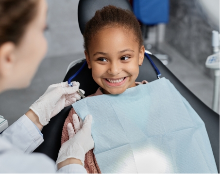 child smling in dental chair