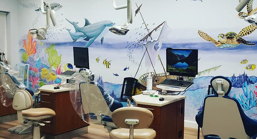 Ocean themed mural on wall of dental treatment area