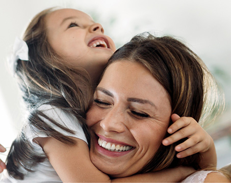 Laughing woman hugging her daughter
