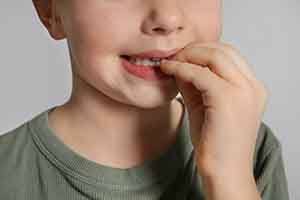 Closeup of child biting his nails