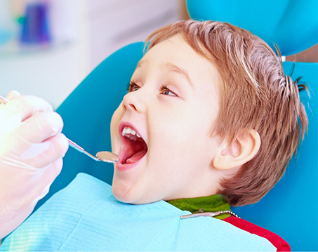 Child opening their mouth for a dental checkup