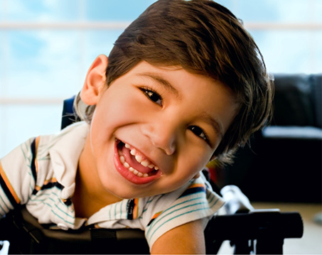 Child with brown hair grinning