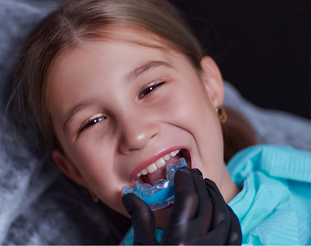 Child receiving a nightguard from their dentist