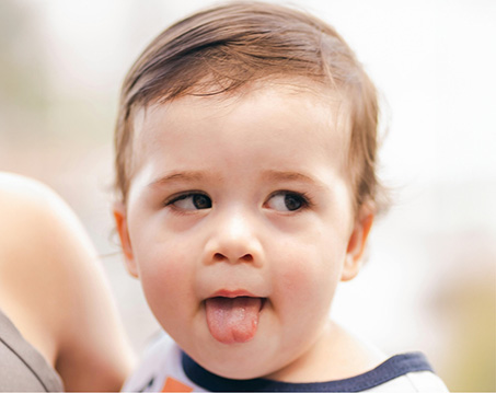 Toddler sticking their tongue out