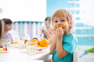 Child eating a slice of bell pepper